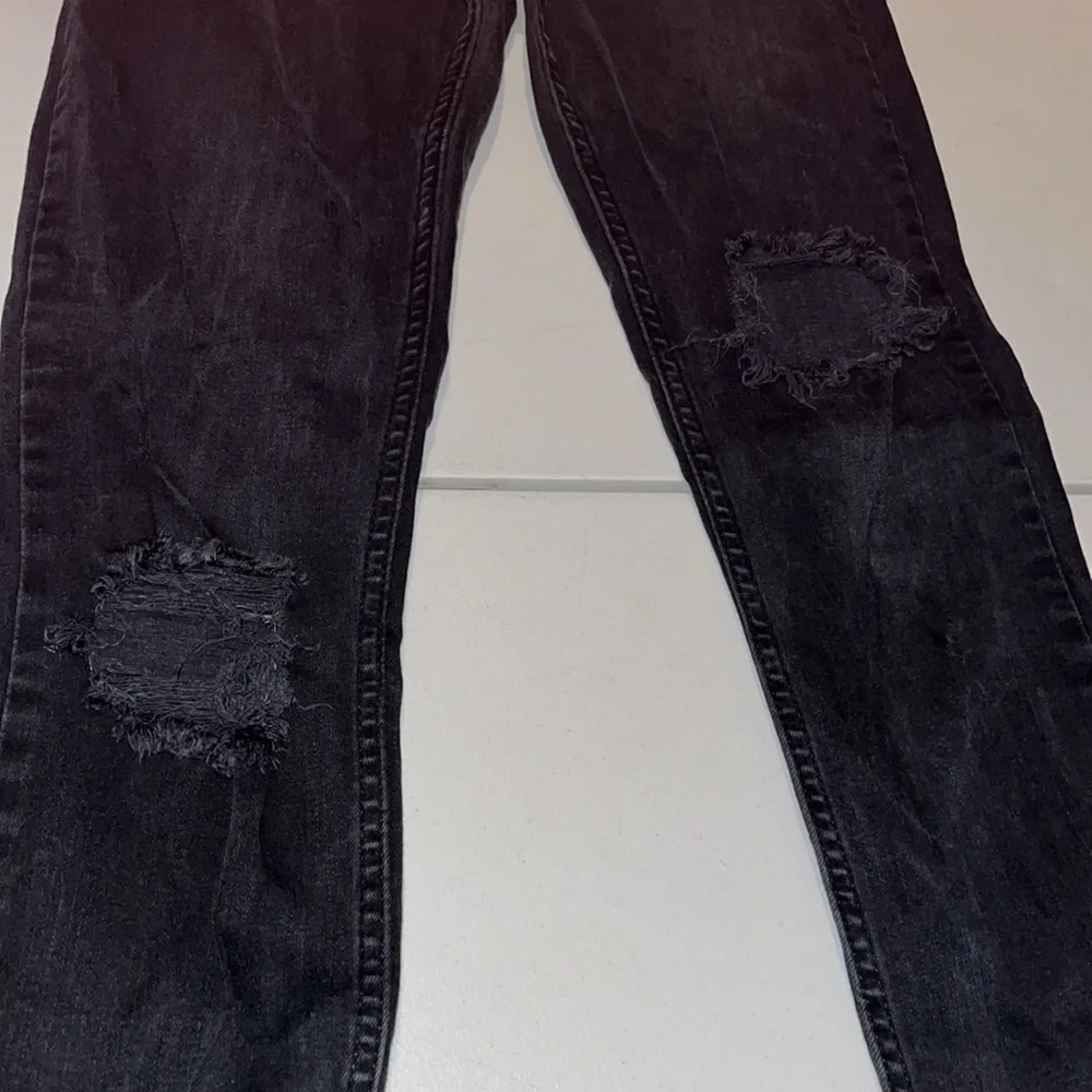 Free People size 27 Black Wash skinny jeans distressed with raw hem